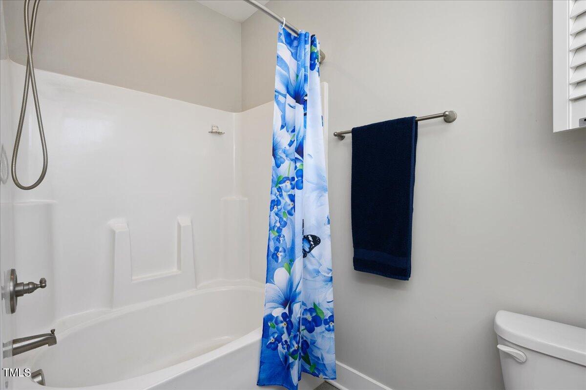 1415 Pine Ridge Road Spring Hope, NC 27882 - Photo 18 of 25 a bathroom with a bathtub and a shower