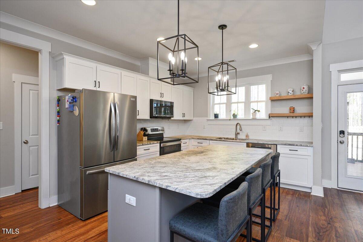 1415 Pine Ridge Road Spring Hope, NC 27882 - Photo 10 of 25 a kitchen with granite countertop cabinets and stainless steel appliances