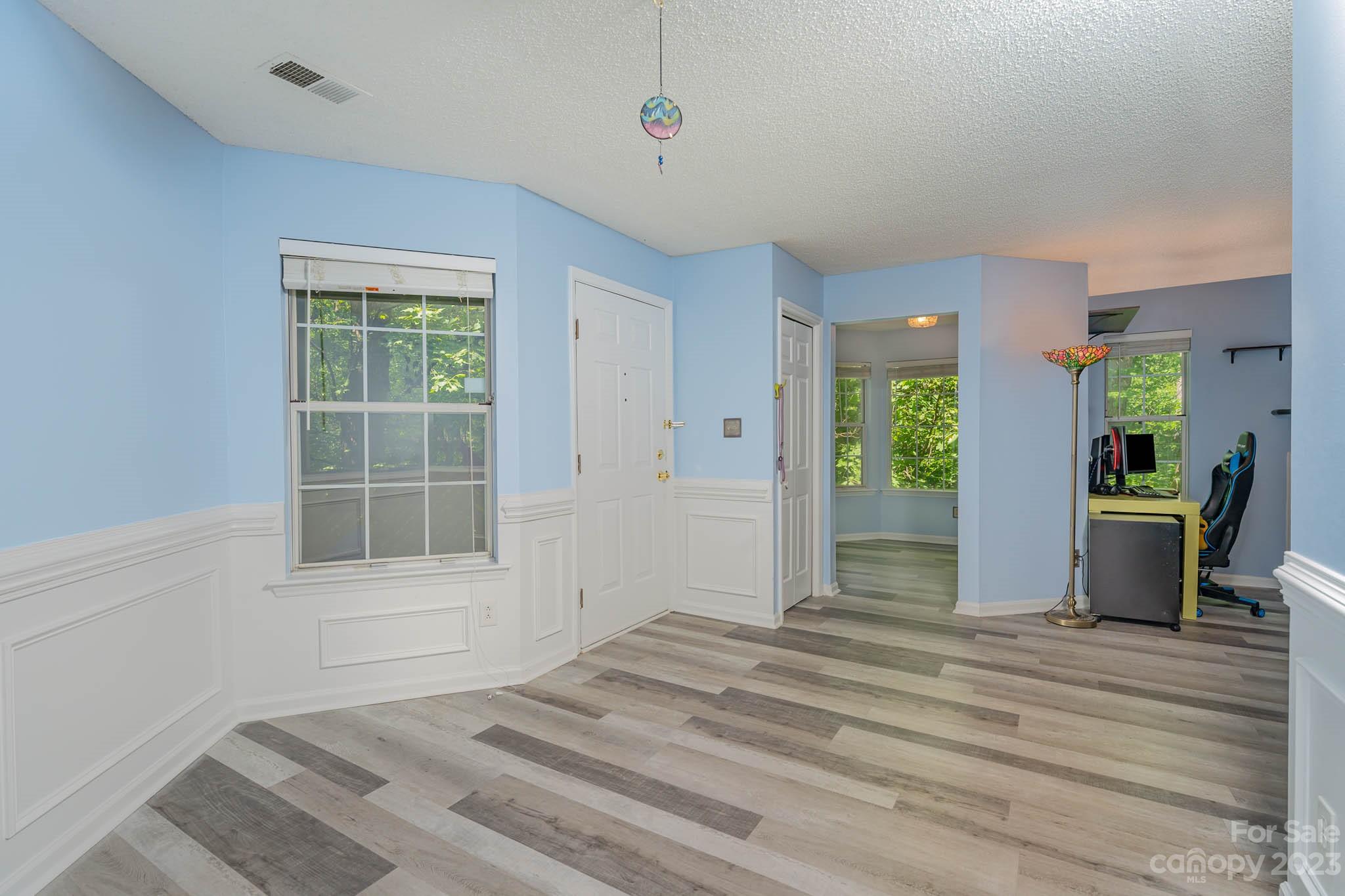 6523 Clavell Lane, Unit E Charlotte, NC 28210 - Photo 9 of 24 a view of empty room with wooden floor and fan