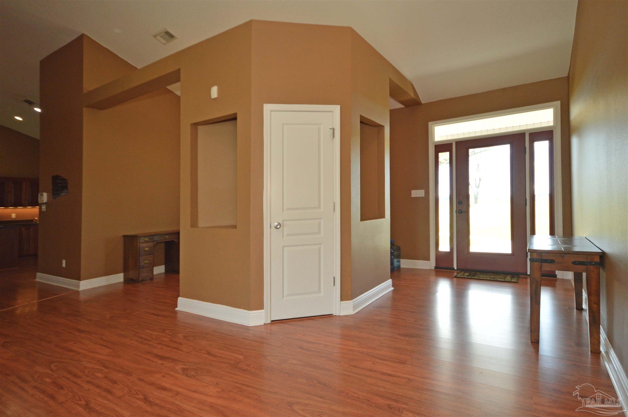 3478 Pine Level Church Road Jay, FL 32565 - Photo 6 of 50 a view of empty room with wooden floor and fan