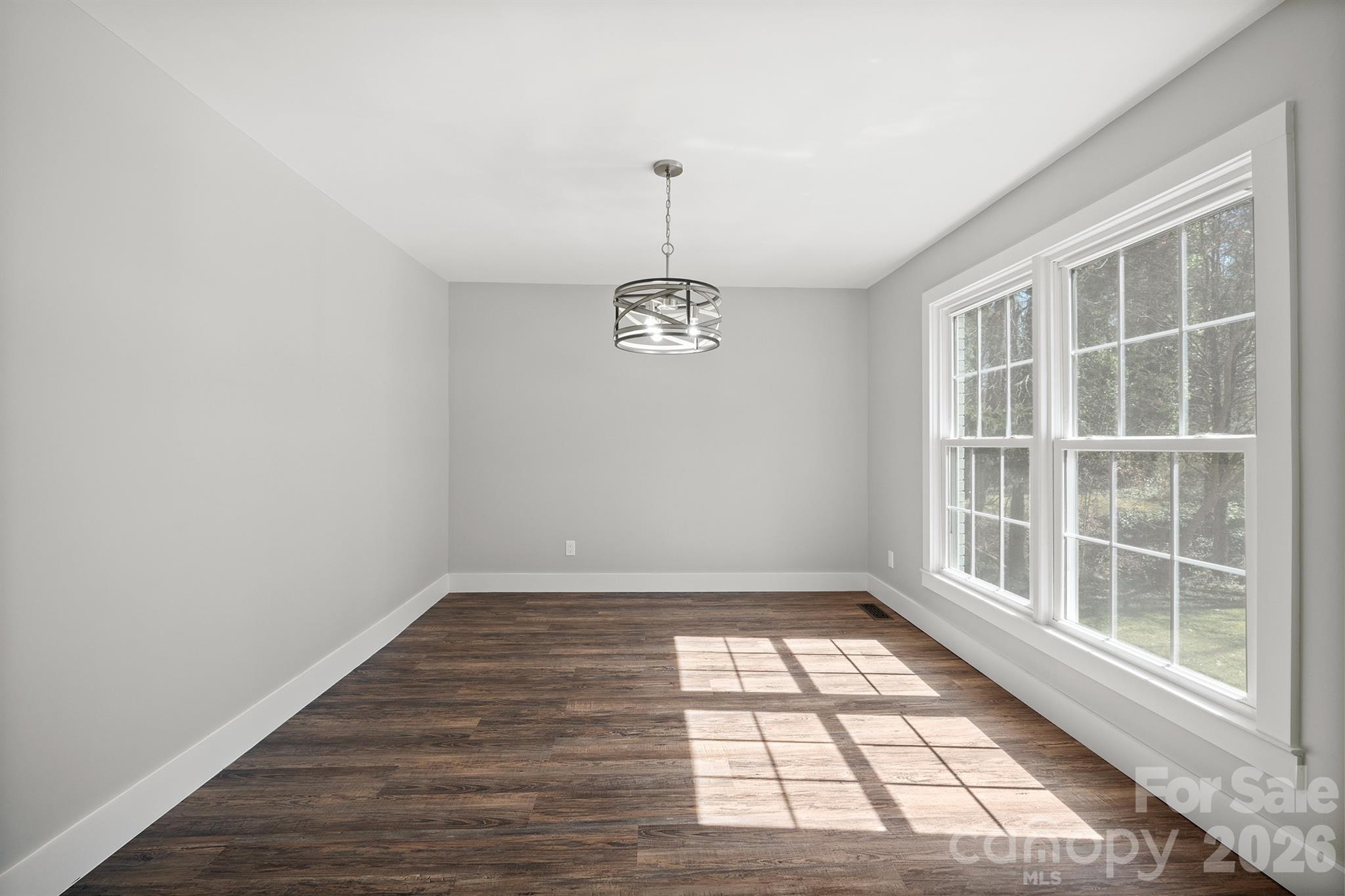 306 7th St Place Northeast Conover, NC 28613 - Photo 14 of 47 a view of empty room with wooden floor and fan