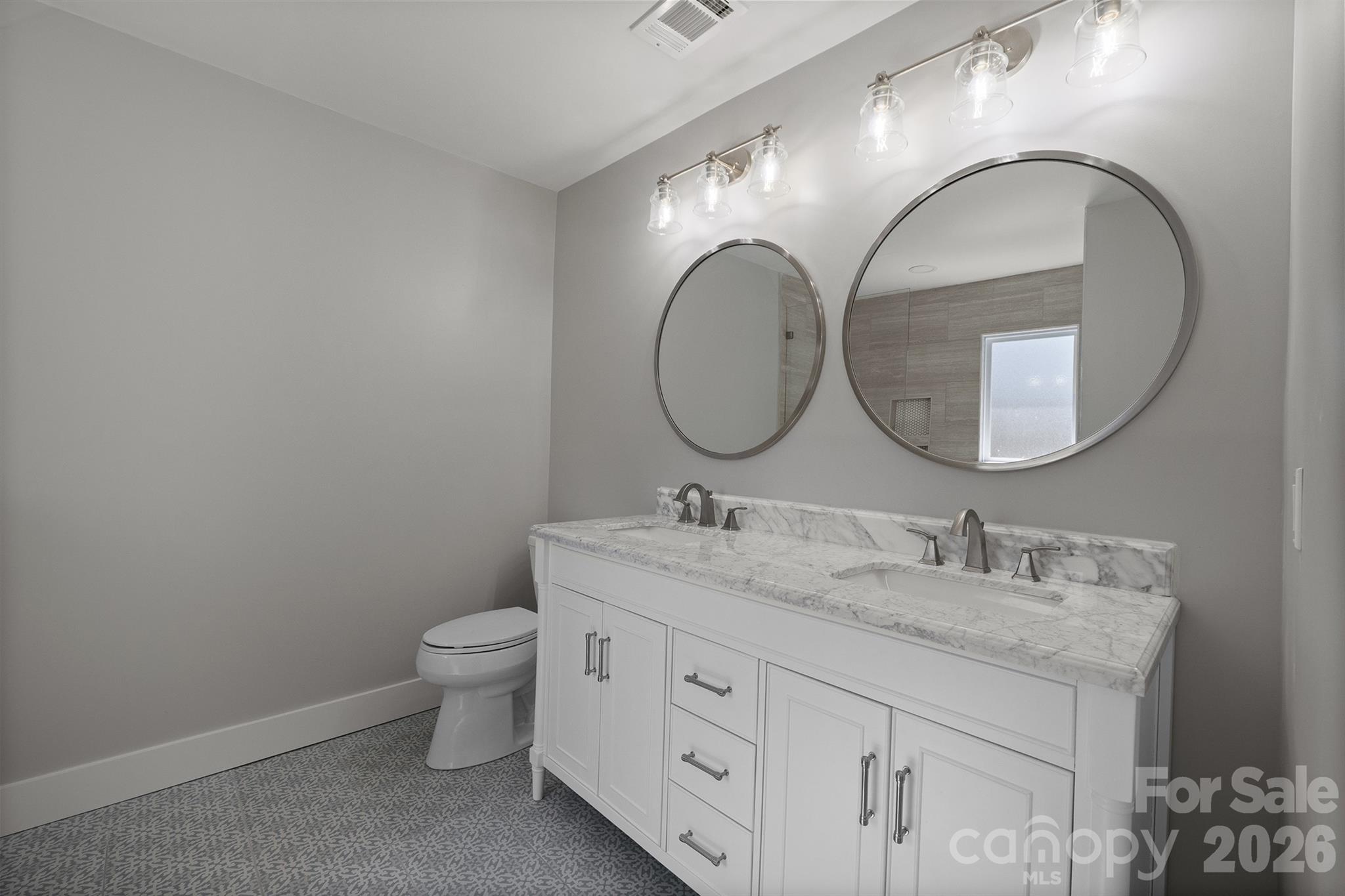 306 7th St Place Northeast Conover, NC 28613 - Photo 34 of 47 a bathroom with a granite countertop toilet a sink and a mirror