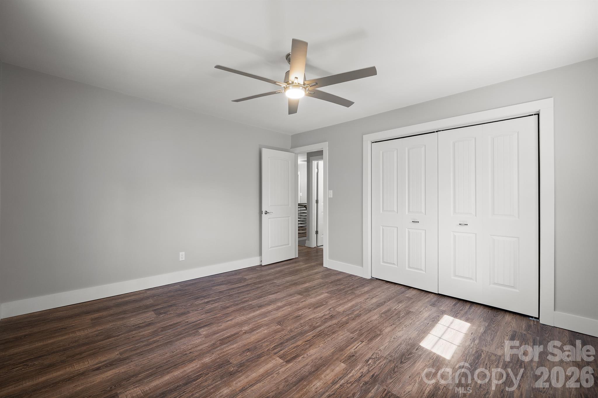 306 7th St Place Northeast Conover, NC 28613 - Photo 40 of 47 an empty room with wooden floor ceiling fan and windows