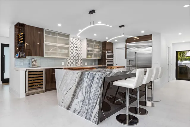 a large kitchen with a table and chairs