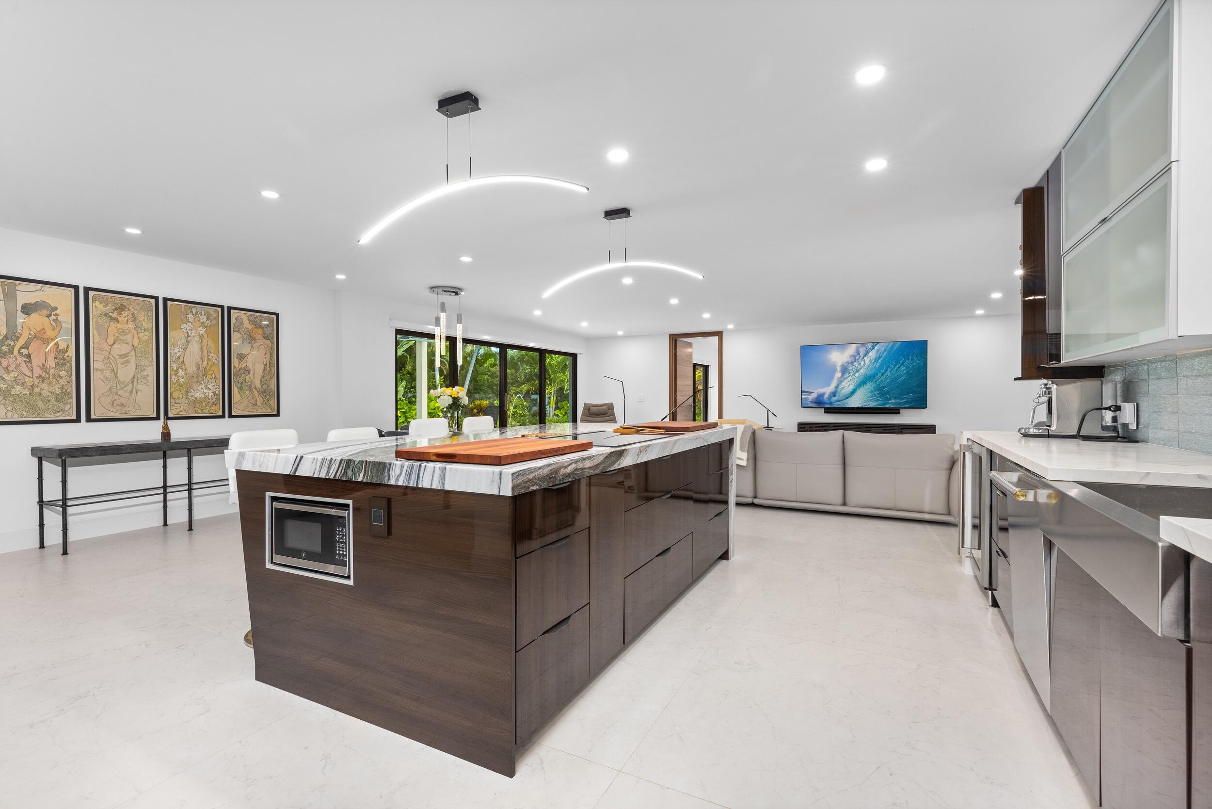 843 Northeast Mulberry Drive Boca Raton, FL 33487 - Photo 16 of 57 a kitchen with kitchen island granite countertop a stove and a sink
