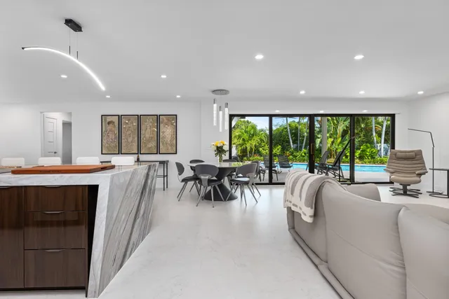 a living room with furniture a large window and a table