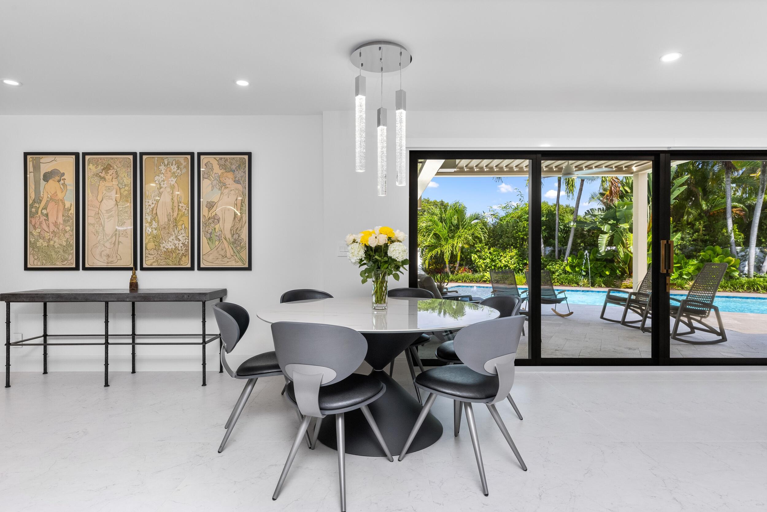 843 Northeast Mulberry Drive Boca Raton, FL 33487 - Photo 18 of 57 a dining room with furniture and a large window