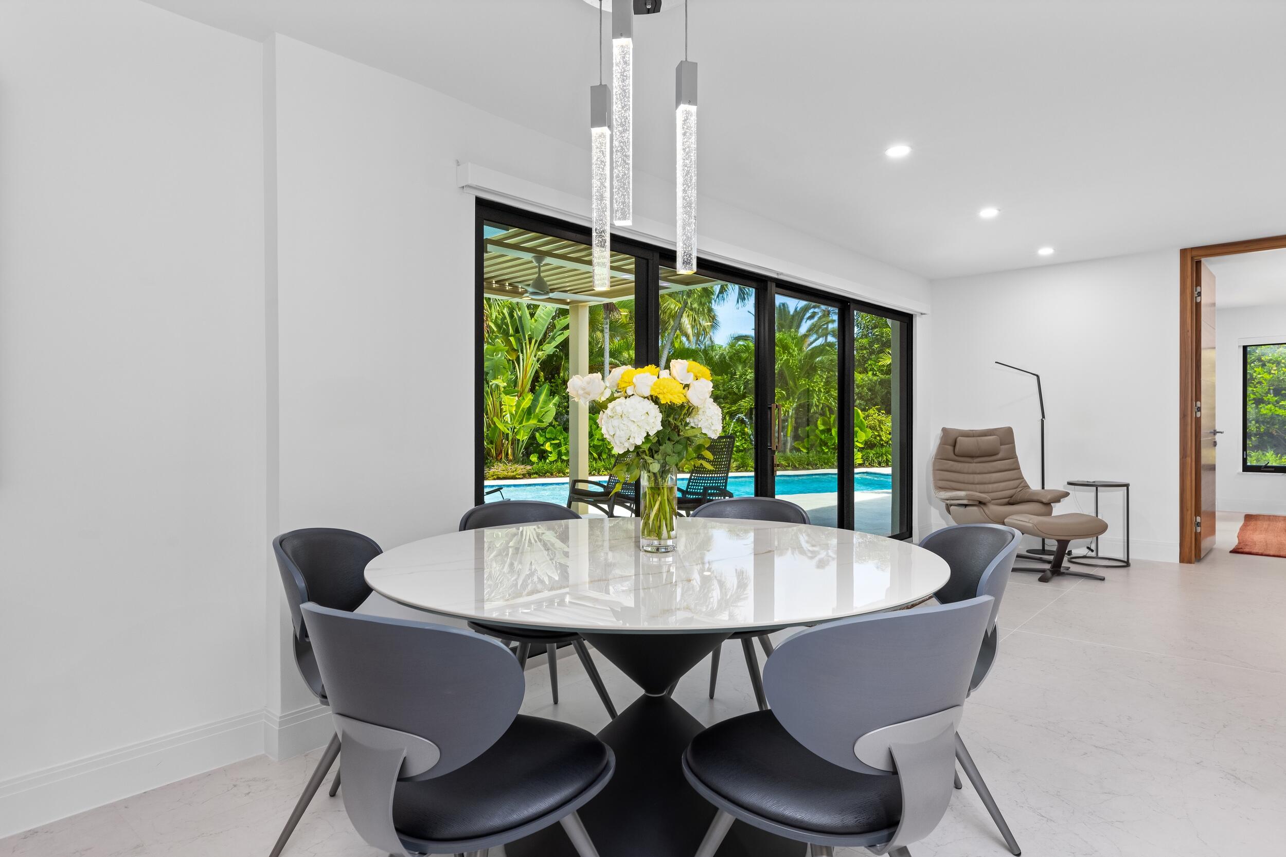 843 Northeast Mulberry Drive Boca Raton, FL 33487 - Photo 19 of 57 a view of a dining room with furniture window and outside view