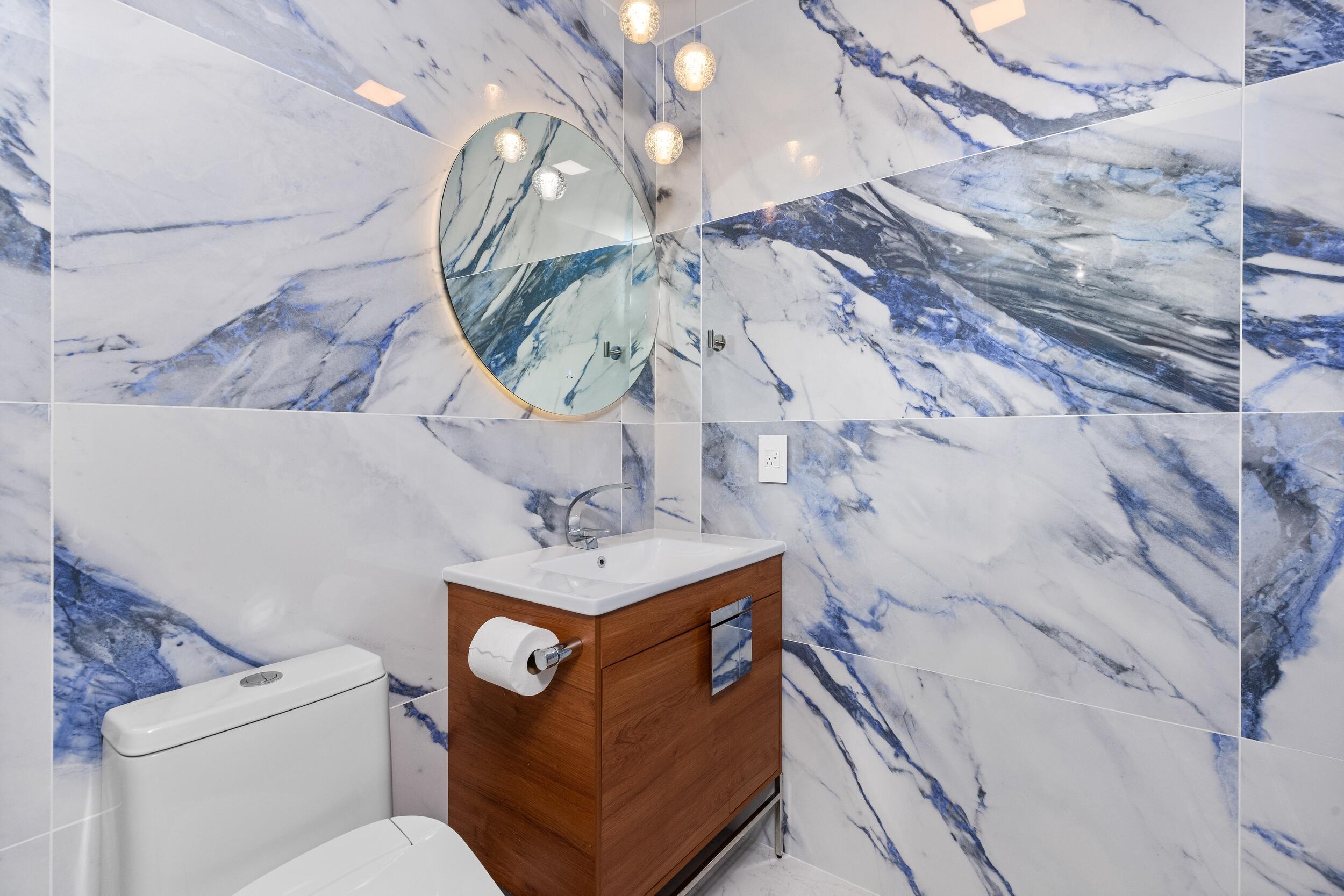 843 Northeast Mulberry Drive Boca Raton, FL 33487 - Photo 23 of 57 a bathroom with a toilet sink and mirror