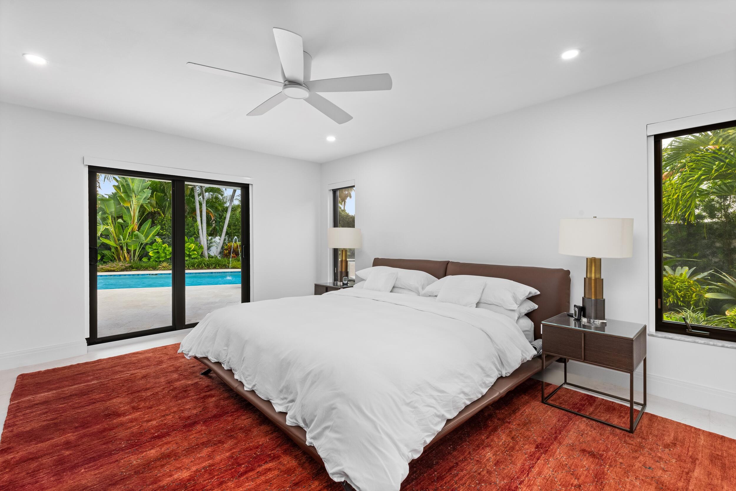 843 Northeast Mulberry Drive Boca Raton, FL 33487 - Photo 25 of 57 a bedroom with a bed and a large window