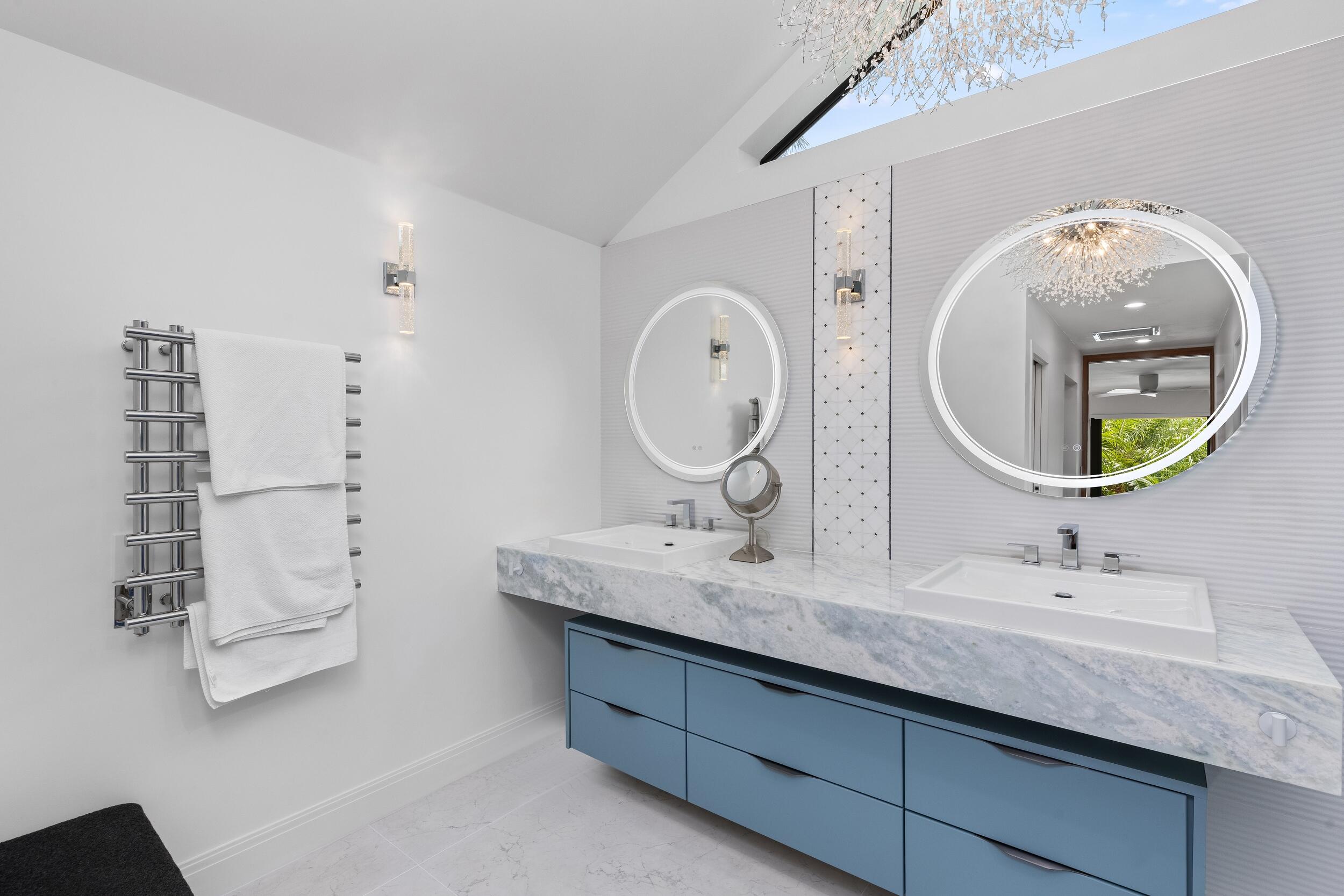 843 Northeast Mulberry Drive Boca Raton, FL 33487 - Photo 29 of 57 a bathroom with a double vanity sink and a mirror