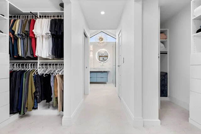a view of walk in closet with clothes