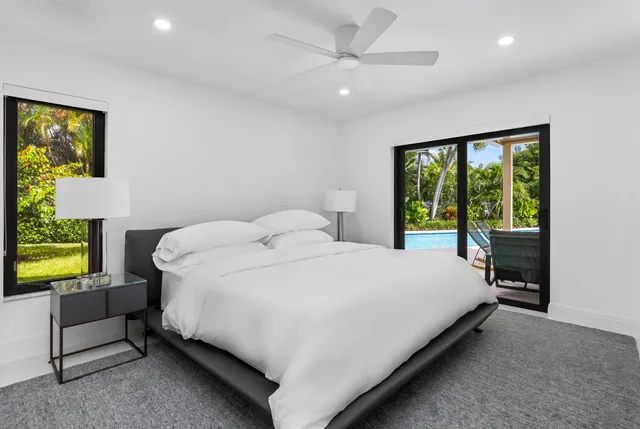 a large bed sitting in a bedroom next to a window