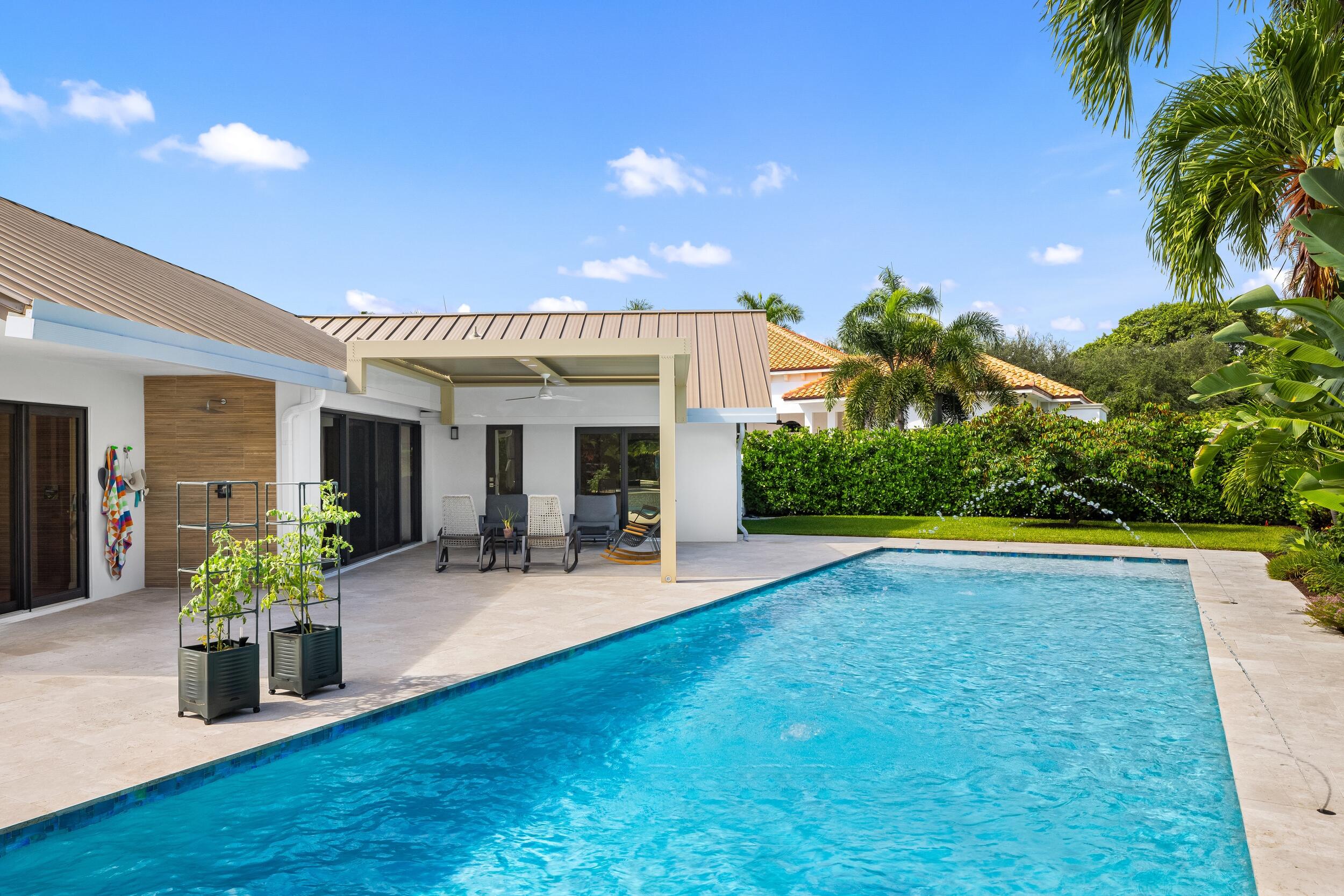 843 Northeast Mulberry Drive Boca Raton, FL 33487 - Photo 39 of 57 a view of a house with swimming pool and sitting area
