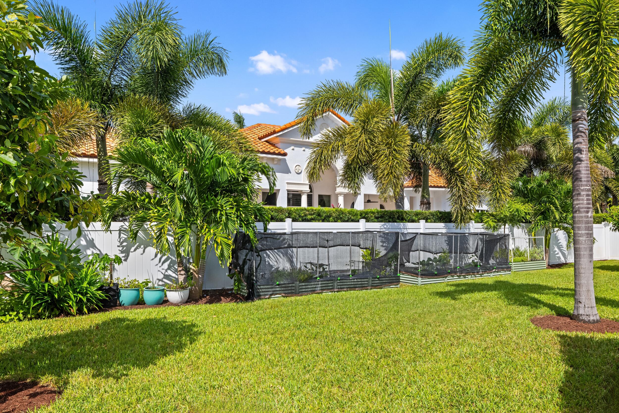 843 Northeast Mulberry Drive Boca Raton, FL 33487 - Photo 45 of 57 a view of house with a garden