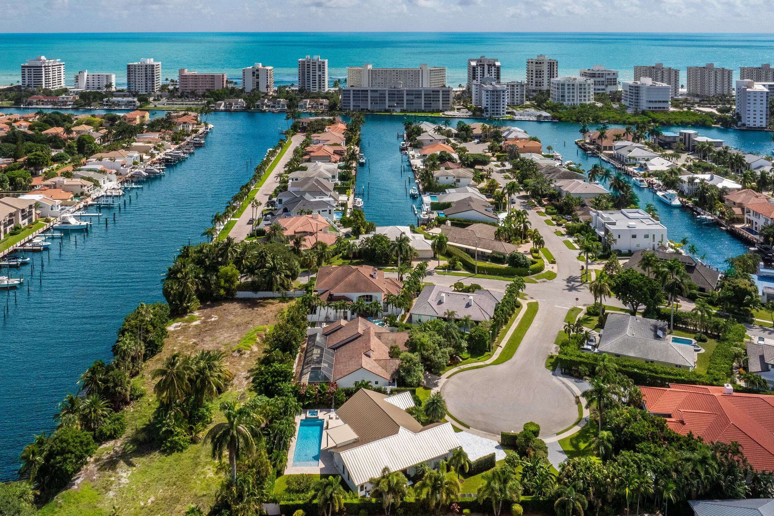 843 Northeast Mulberry Drive Boca Raton, FL 33487 - Photo 50 of 57 an aerial view of a city with lots of residential buildings ocean and mountain view in back