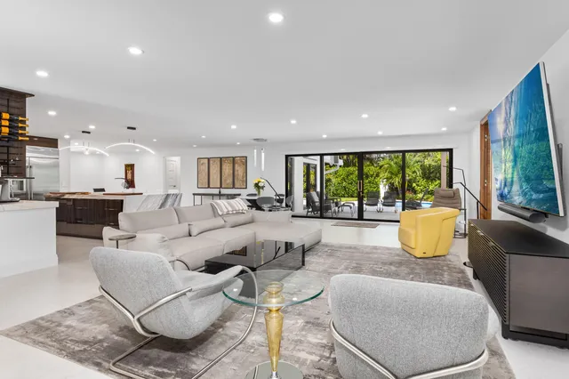 a living room with fireplace furniture and a large window
