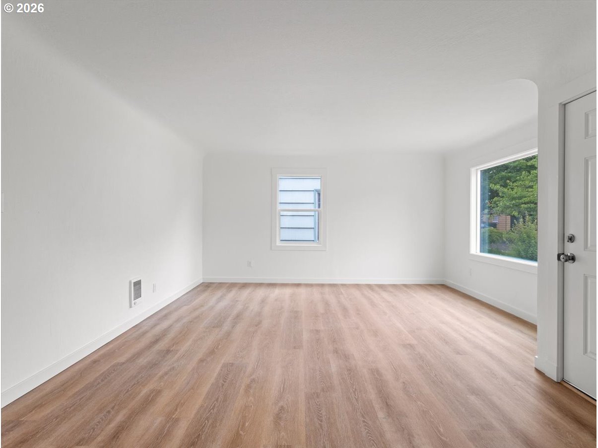 440 25th Avenue Longview, WA 98632 - Photo 4 of 27 an empty room with wooden floor and windows