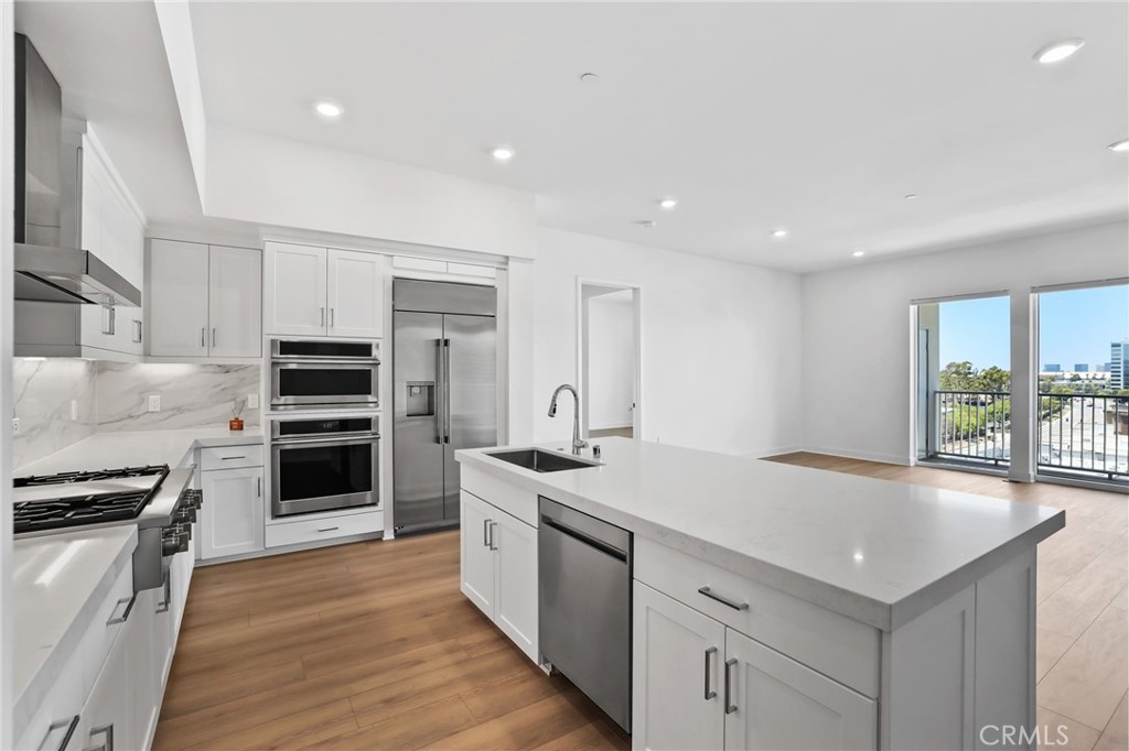 a kitchen with a sink stove and refrigerator