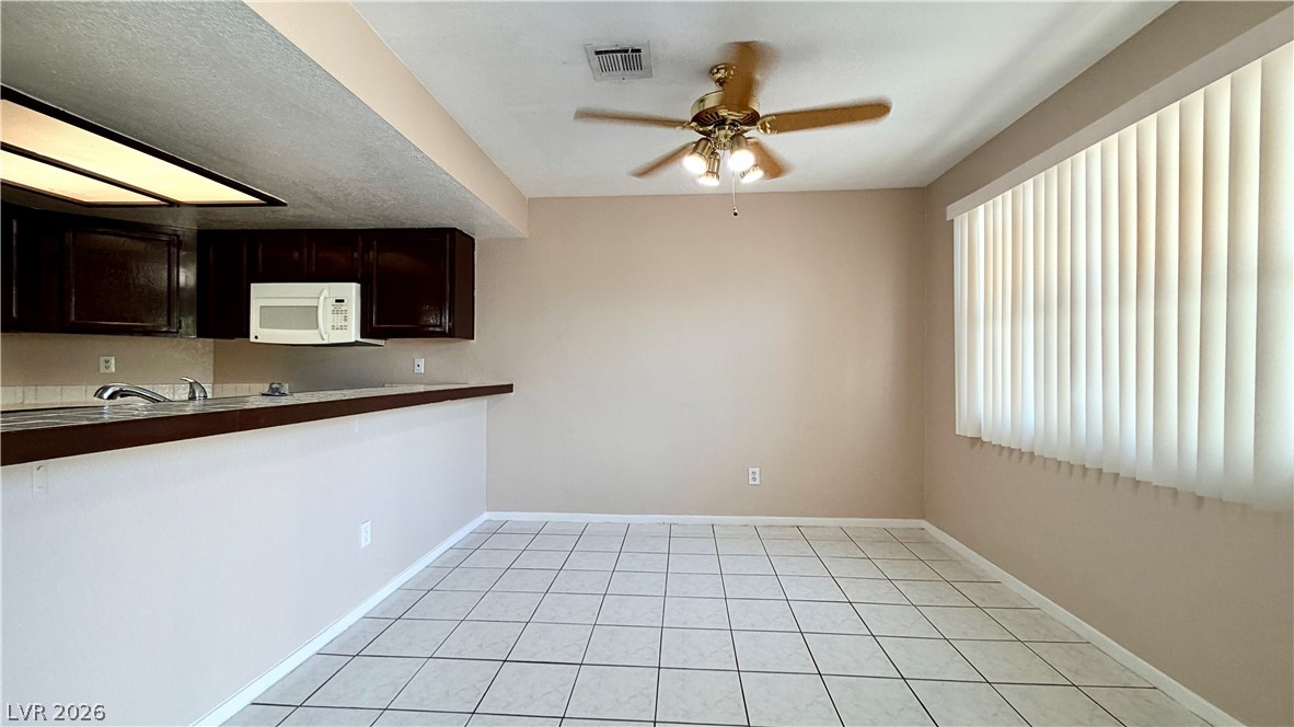 6250 West Flamingo Road, Unit 4 Las Vegas, NV 89103 - Photo 7 of 45 Bright and open, this eat-in kitchen area features ample natural light and clean lines.
