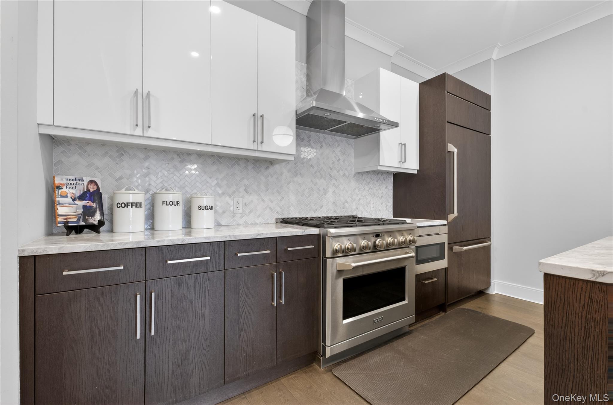 100 Garvies Point Road, Unit 1332 Glen Cove, NY 11542 - Photo 12 of 45 a kitchen with stainless steel appliances granite countertop a stove and a sink