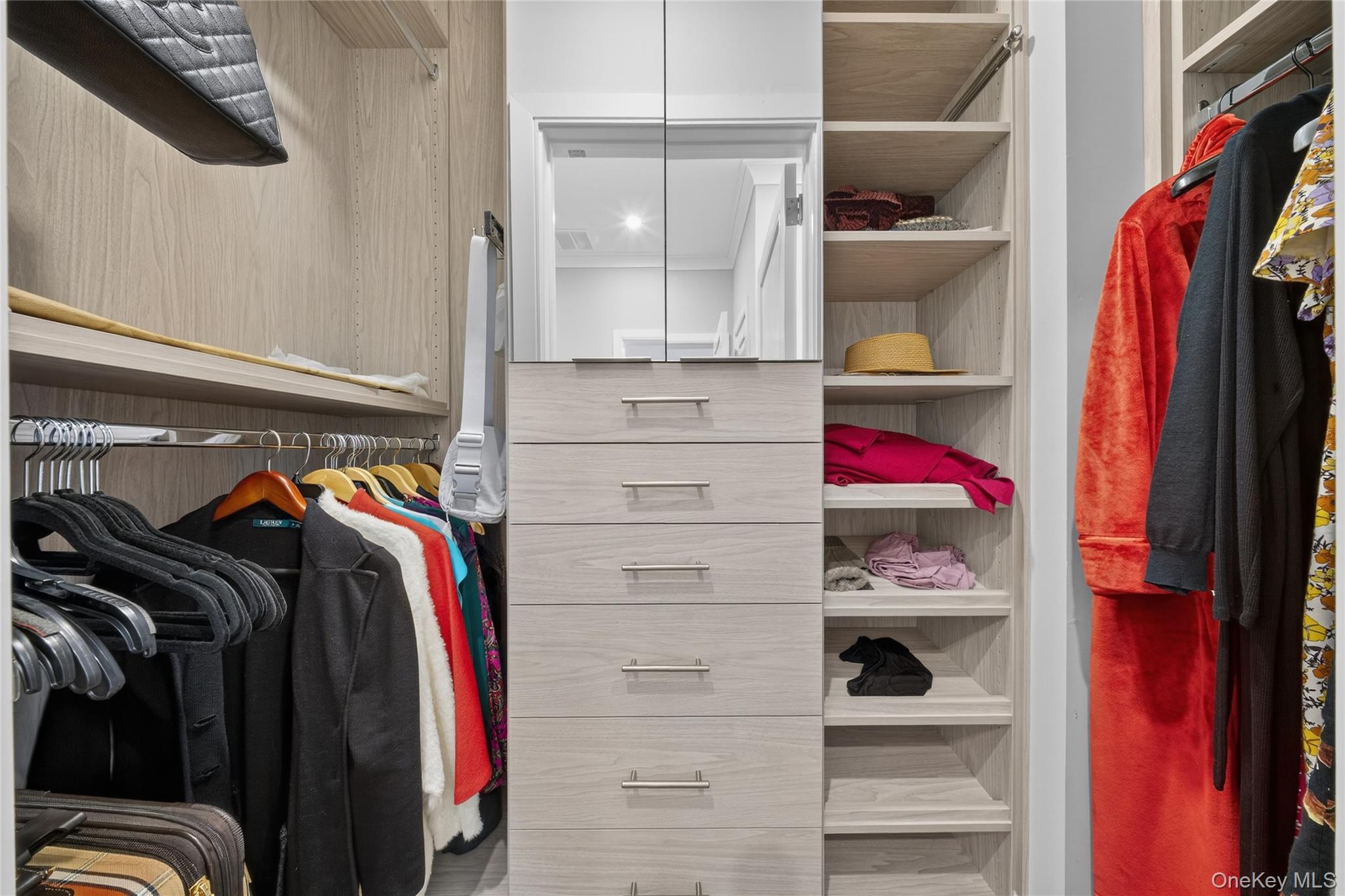100 Garvies Point Road, Unit 1332 Glen Cove, NY 11542 - Photo 16 of 45 a view of walk in closet with clothes and shoes