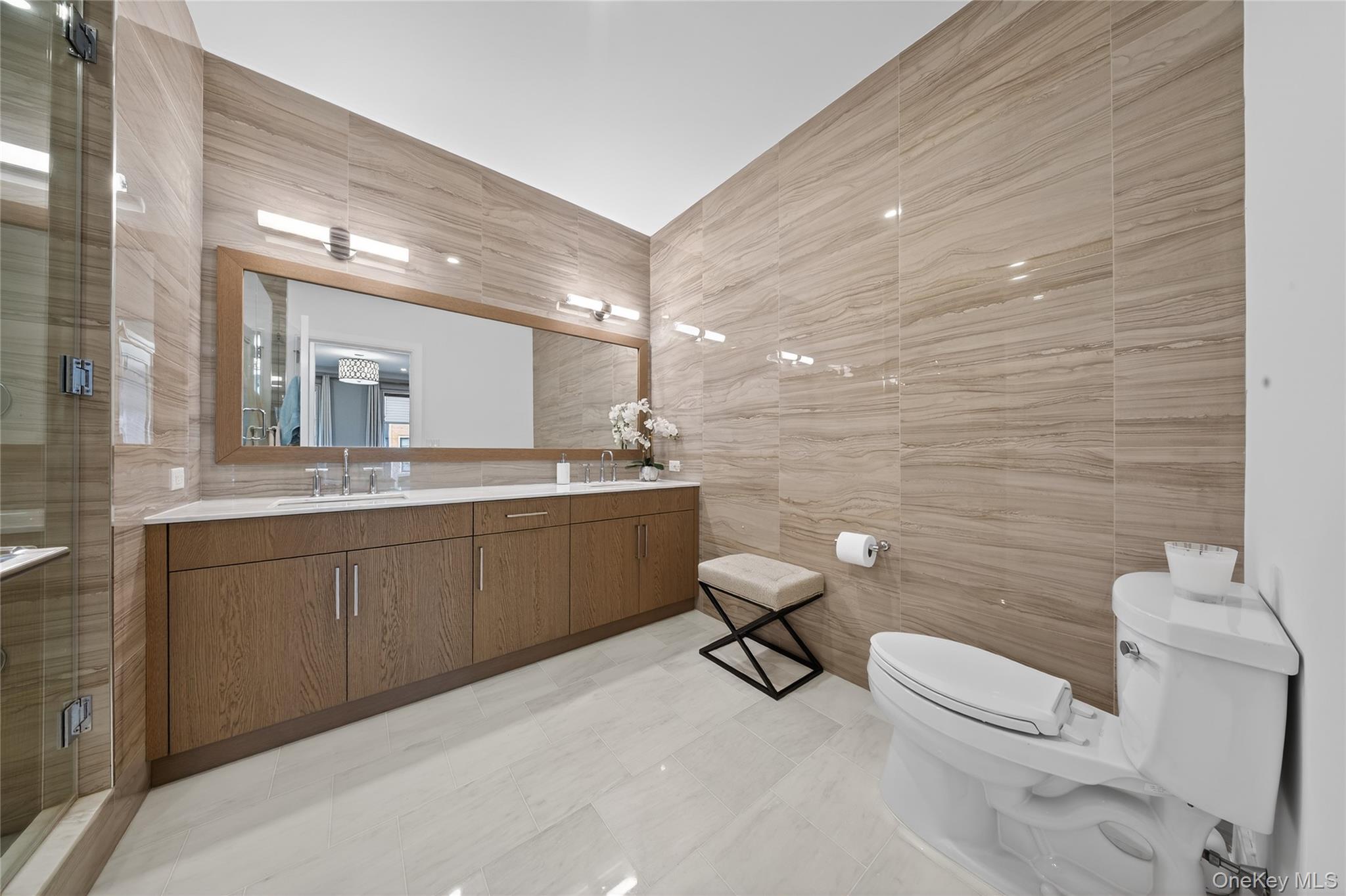 100 Garvies Point Road, Unit 1332 Glen Cove, NY 11542 - Photo 19 of 45 a bathroom with a toilet sink and mirror