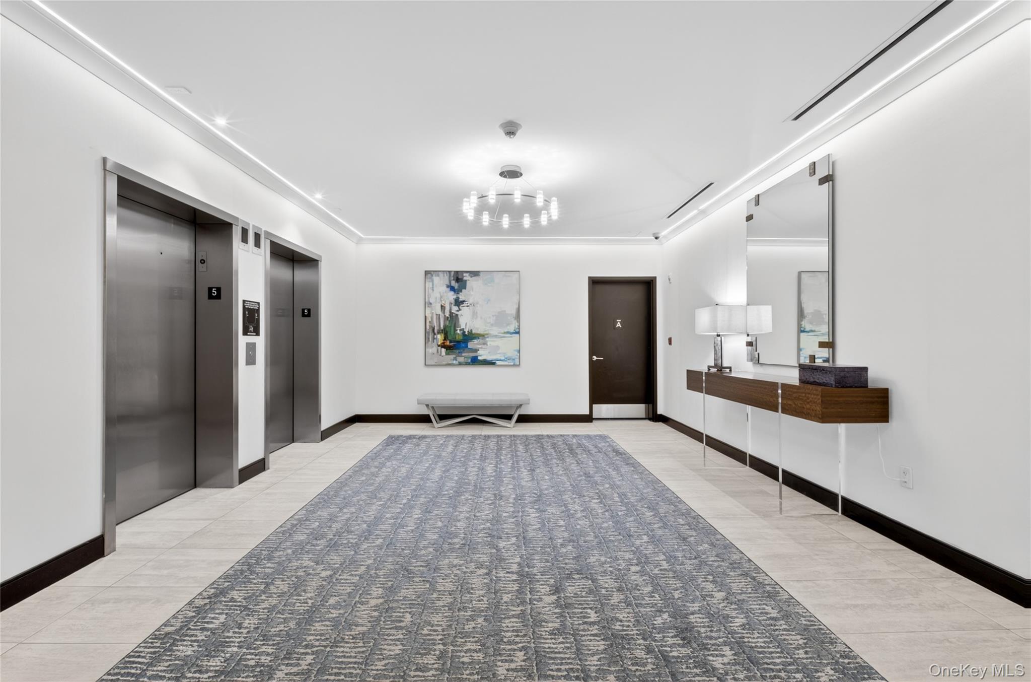 100 Garvies Point Road, Unit 1332 Glen Cove, NY 11542 - Photo 30 of 45 a view of a hallway with a chandelier
