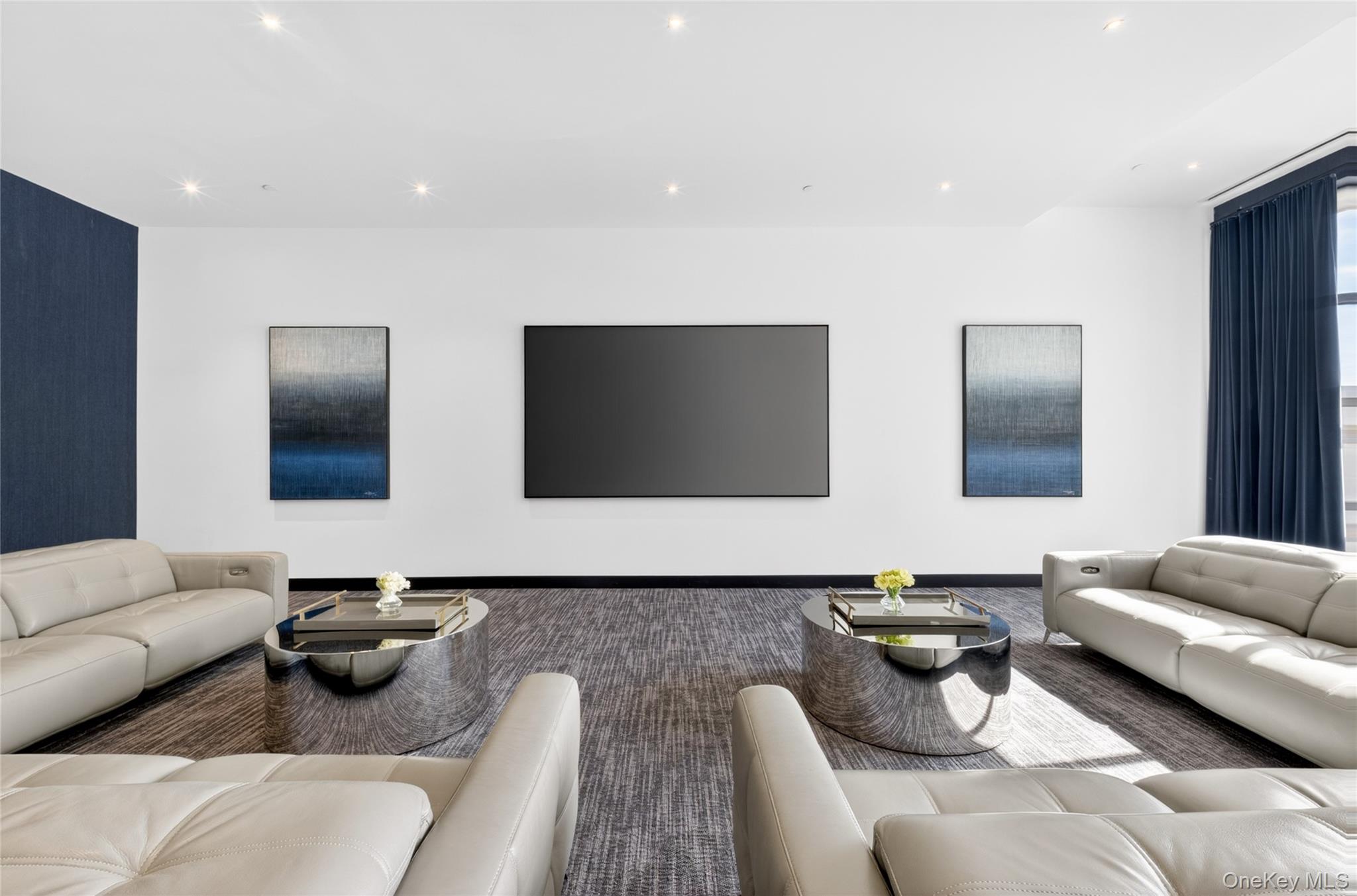 100 Garvies Point Road, Unit 1332 Glen Cove, NY 11542 - Photo 43 of 45 a living room with furniture and a flat screen tv