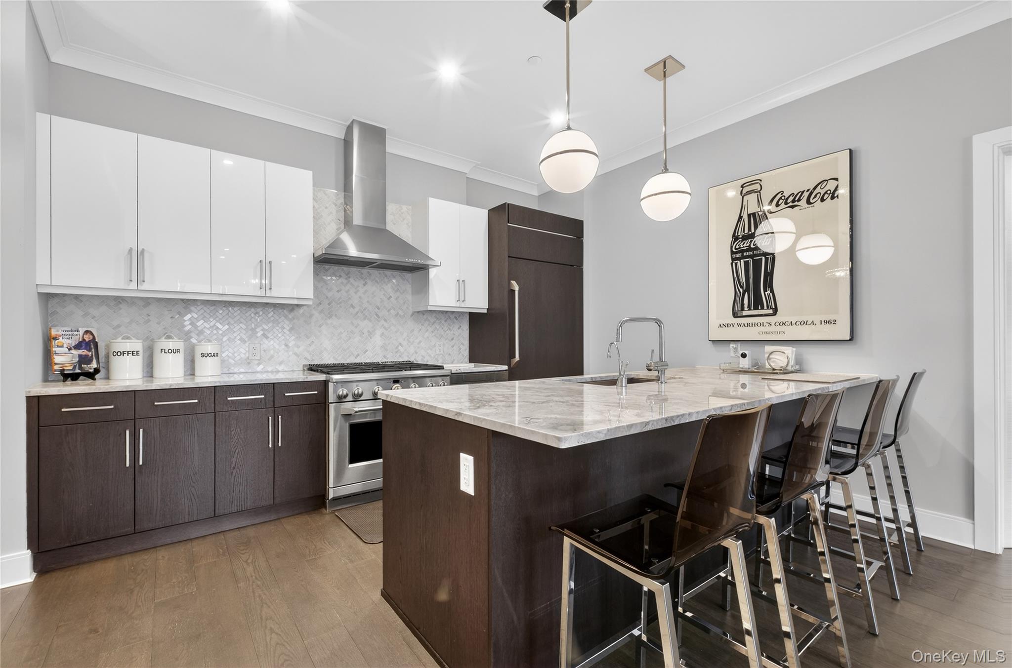 100 Garvies Point Road, Unit 1332 Glen Cove, NY 11542 - Photo 9 of 45 a kitchen with cabinets a counter space dining table and a sink