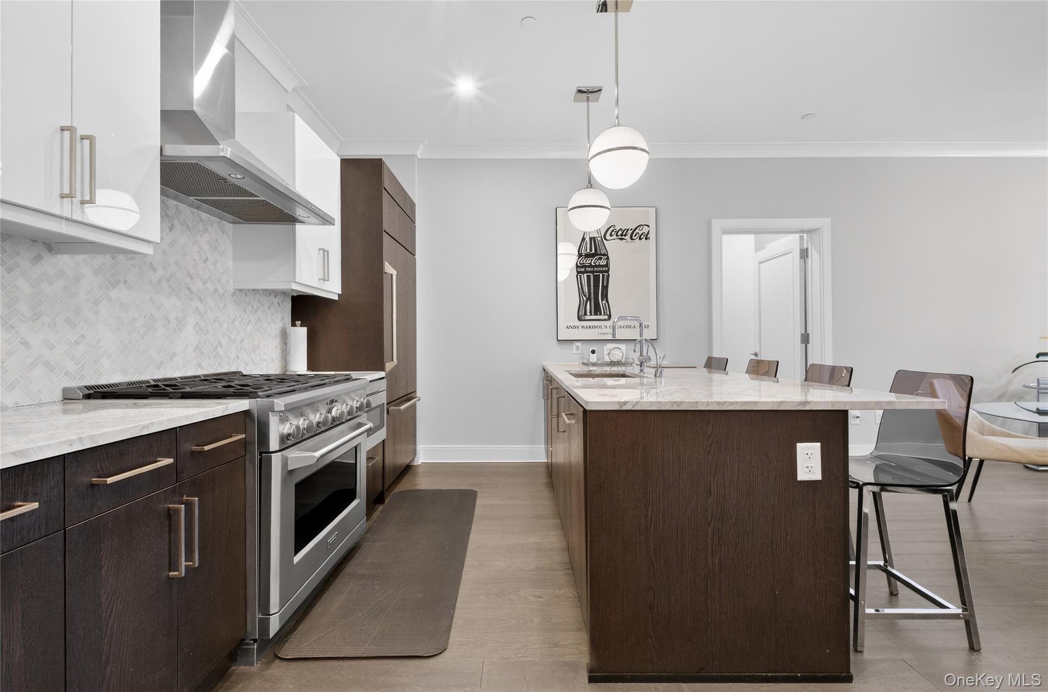 100 Garvies Point Road, Unit 1332 Glen Cove, NY 11542 - Photo 10 of 45 a kitchen with stainless steel appliances granite countertop a sink a stove and a refrigerator