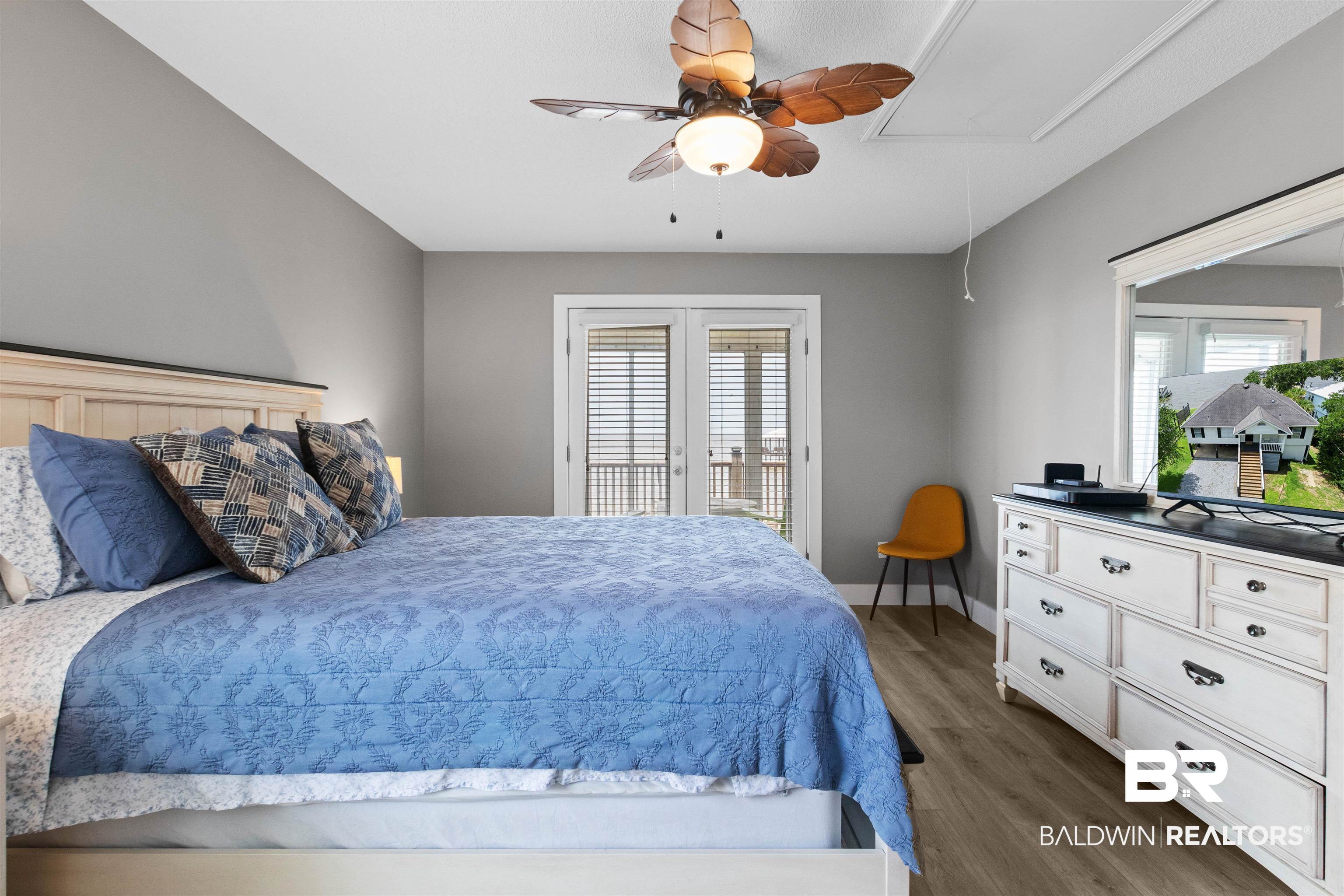 9581 South Bay Street Foley, AL 36535 - Photo 21 of 44 Bedroom featuring wood-finish flooring, a ceiling fan with leaf-shaped blades, and neutral gray walls
