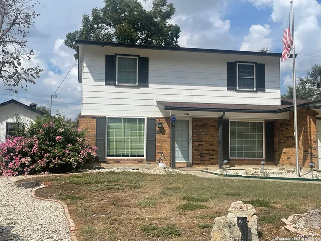 front view of a house with a yard