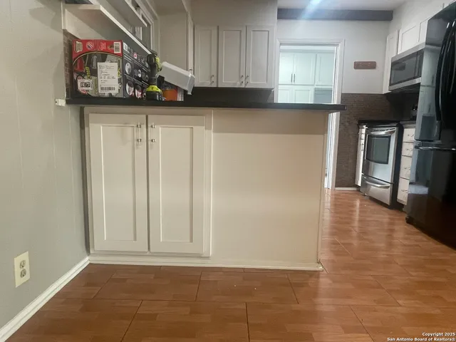 a kitchen with stainless steel appliances a refrigerator and a stove