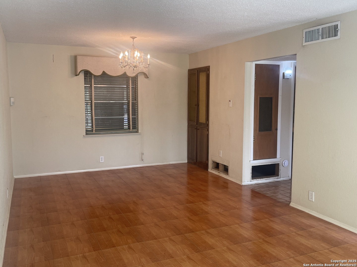 9411 Wahada Avenue San Antonio, TX 78217 - Photo 18 of 49 a view of an empty room with chandelier and a window