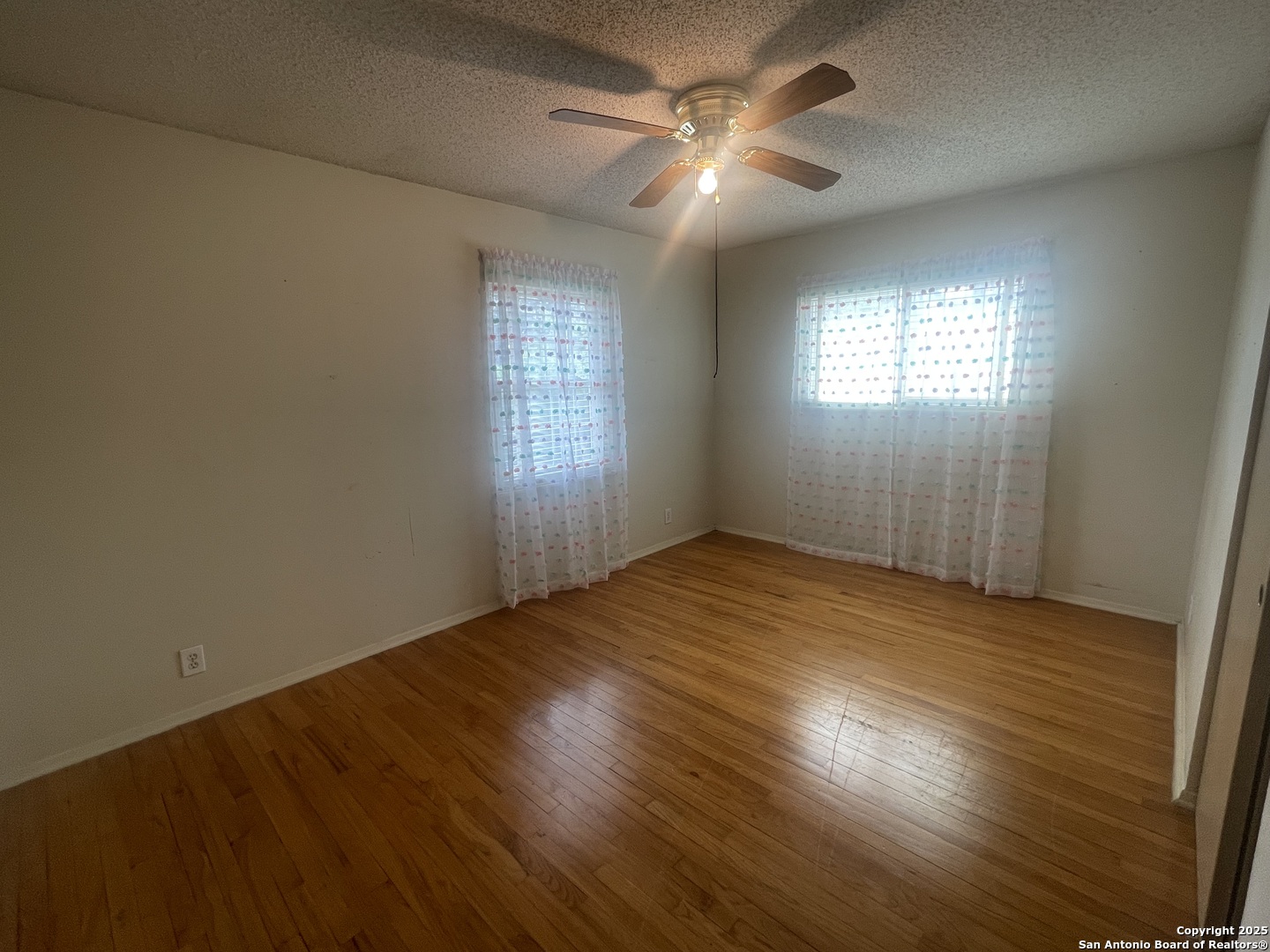 9411 Wahada Avenue San Antonio, TX 78217 - Photo 24 of 49 an empty room with wooden floor and windows