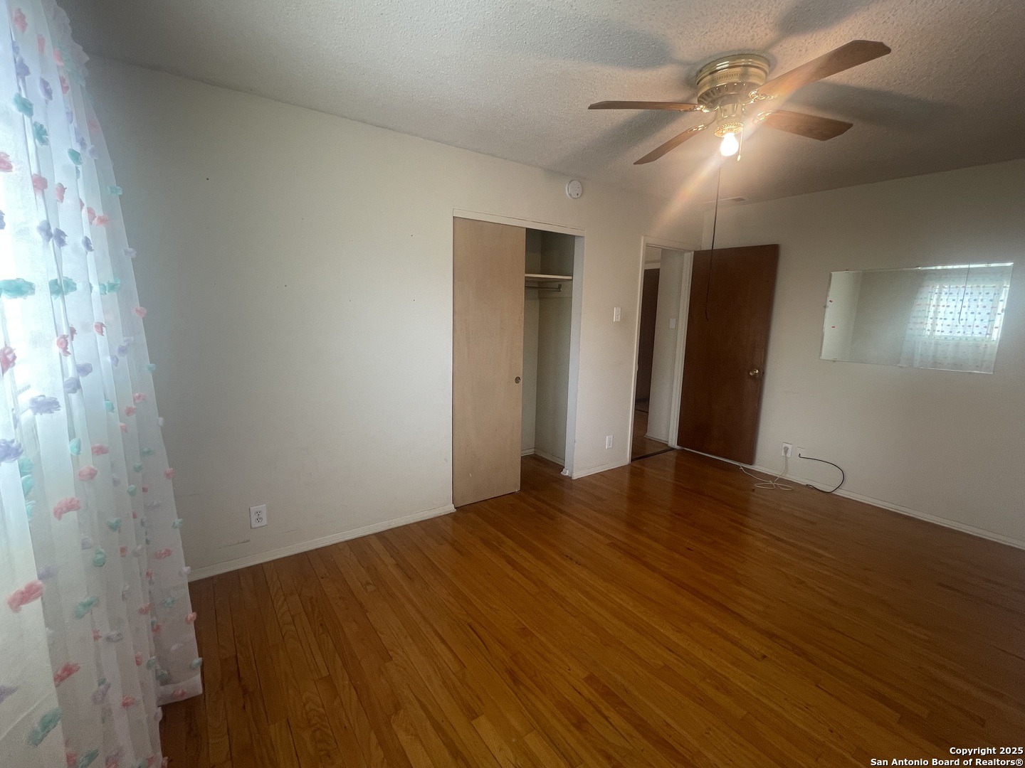 9411 Wahada Avenue San Antonio, TX 78217 - Photo 25 of 49 a view of an empty room with wooden floor
