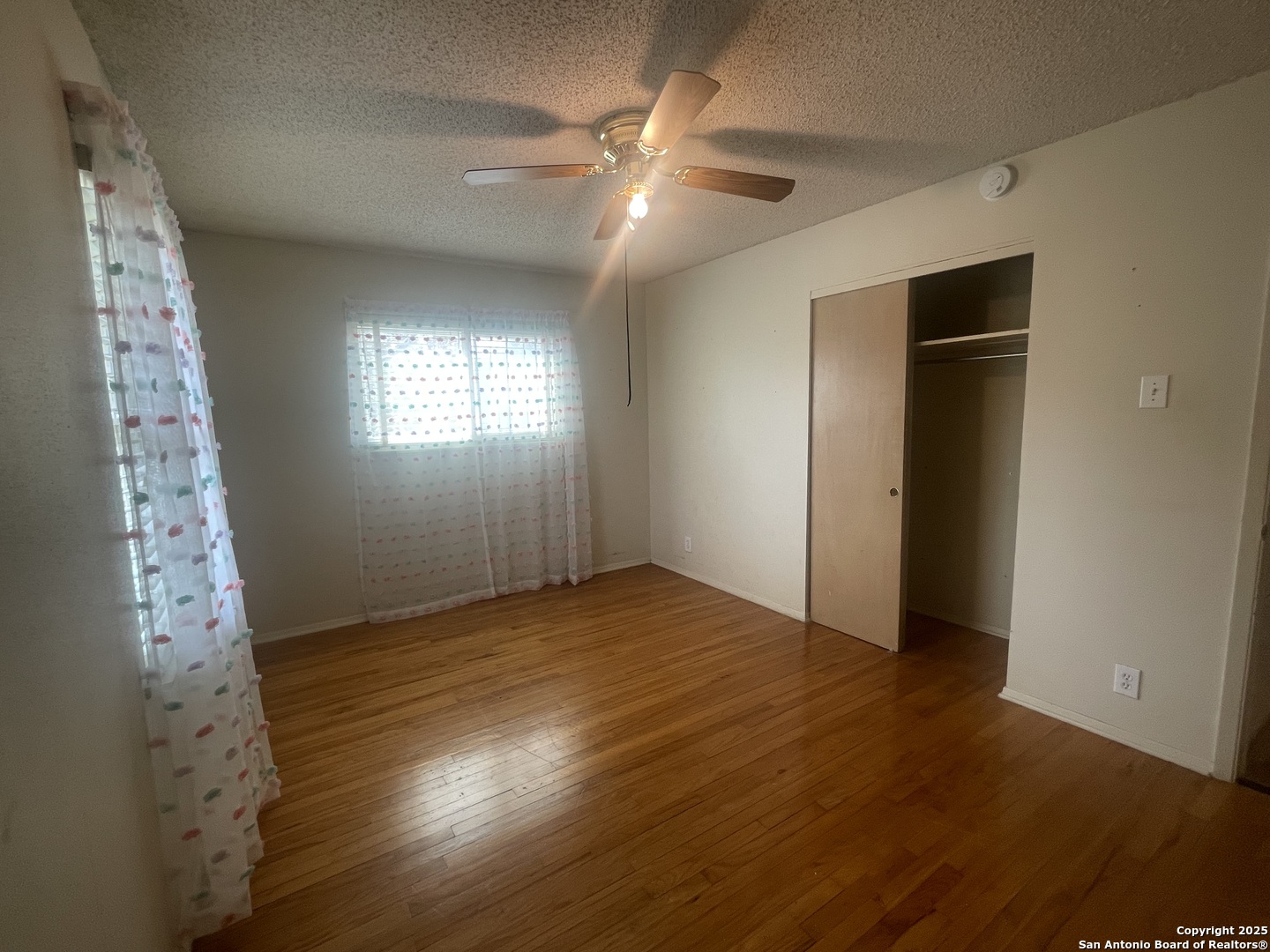 9411 Wahada Avenue San Antonio, TX 78217 - Photo 26 of 49 a view of an empty room with window and wooden floor