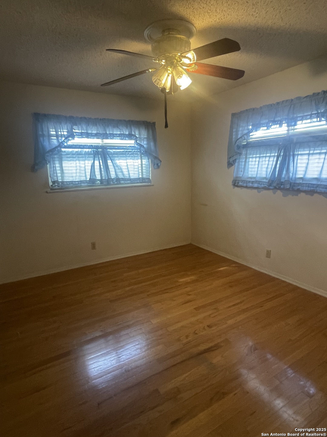 9411 Wahada Avenue San Antonio, TX 78217 - Photo 27 of 49 a view of an empty room with window and chandelier fan