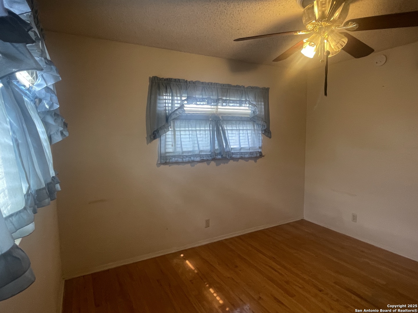 9411 Wahada Avenue San Antonio, TX 78217 - Photo 29 of 49 a view of empty room with wooden floor and fan