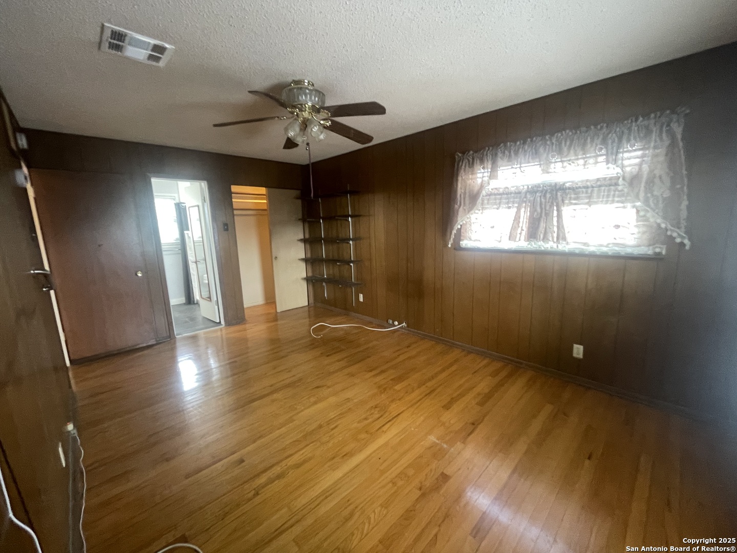 9411 Wahada Avenue San Antonio, TX 78217 - Photo 31 of 49 a view of an empty room with a window and wooden floor