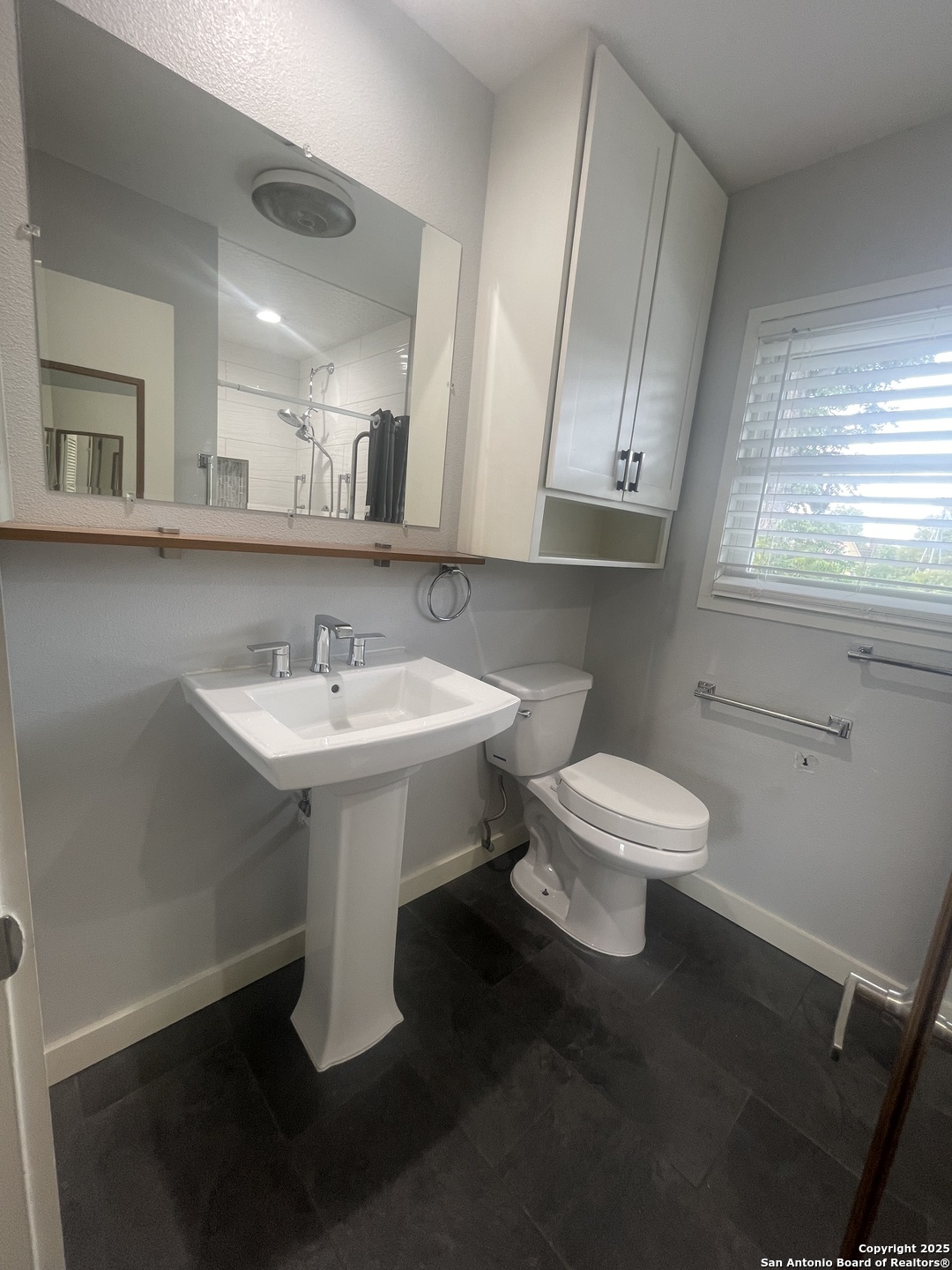 9411 Wahada Avenue San Antonio, TX 78217 - Photo 33 of 49 a bathroom with a sink toilet and a mirror