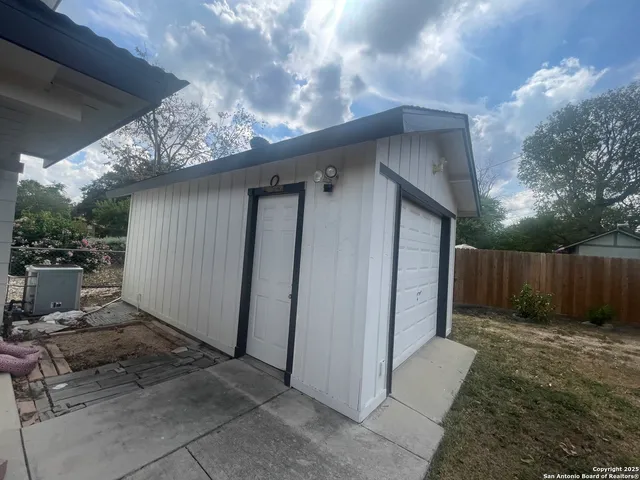 a backyard of a house with garage