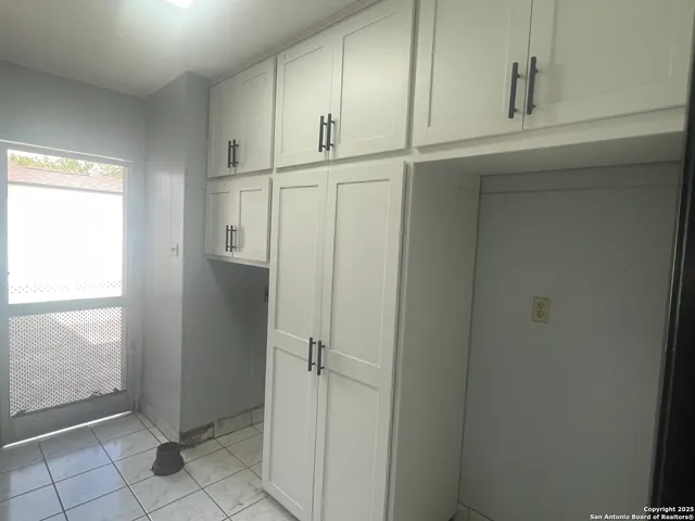 a view of a kitchen with a sink and a chandelier