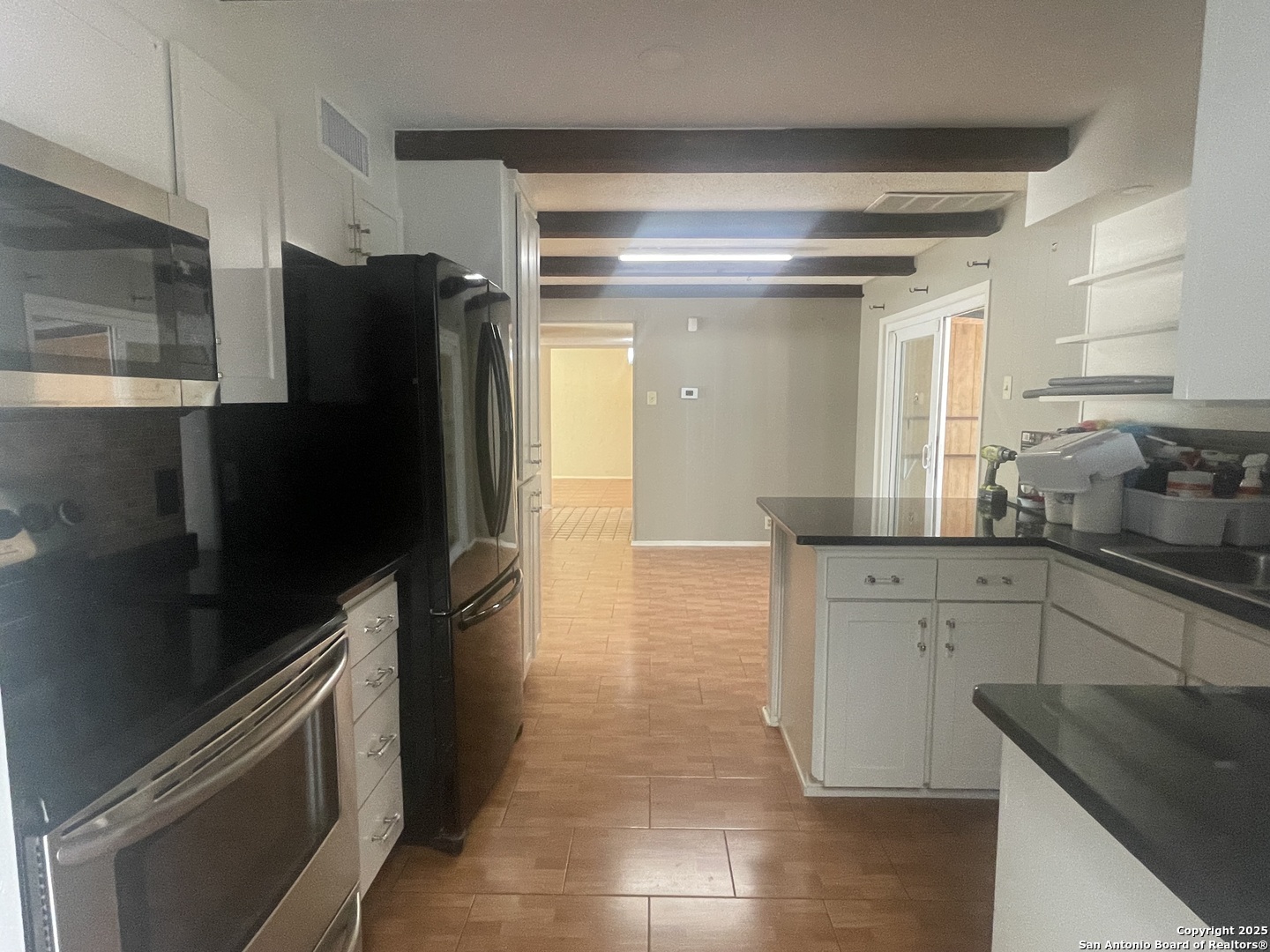 9411 Wahada Avenue San Antonio, TX 78217 - Photo 5 of 49 a kitchen with a refrigerator and a sink