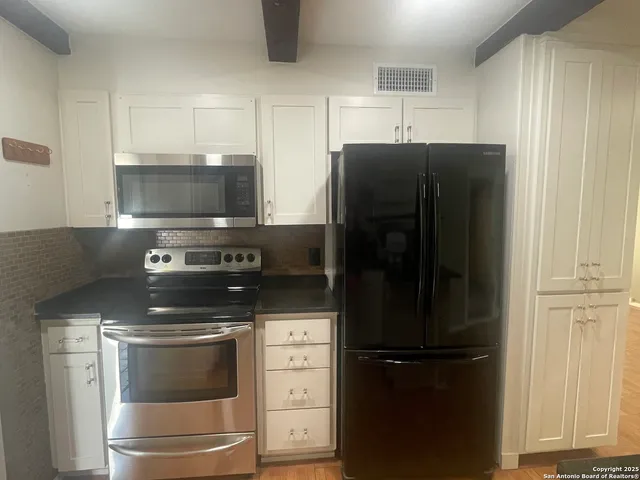a kitchen with appliances and cabinets