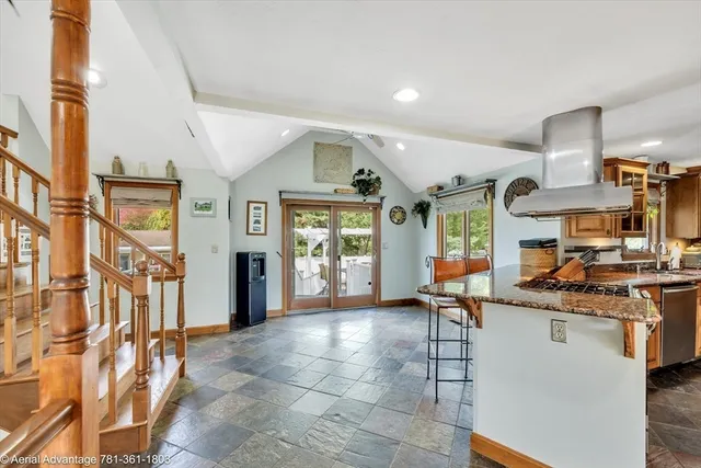 a open kitchen with stainless steel appliances granite countertop a stove and cabinets