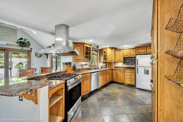 a kitchen with stainless steel appliances granite countertop a stove and a sink