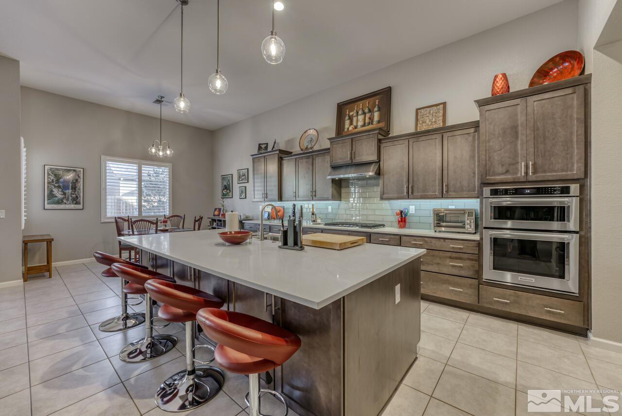 9470 Baldacci Road Reno, NV 89521 - Photo 15 of 35 a kitchen with stainless steel appliances a stove a sink dishwasher and a refrigerator