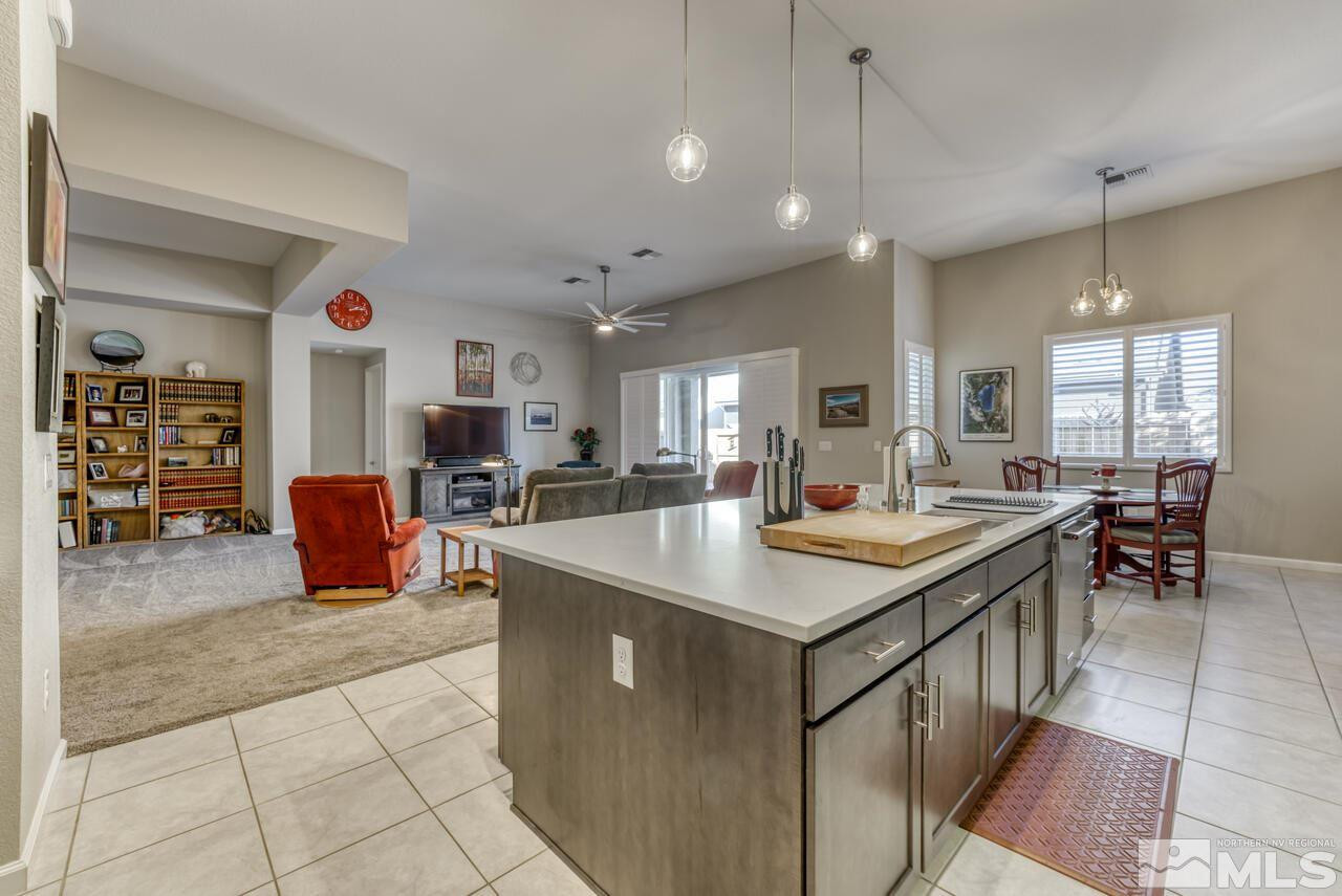 9470 Baldacci Road Reno, NV 89521 - Photo 7 of 35 a kitchen with stainless steel appliances granite countertop a sink a stove and a refrigerator
